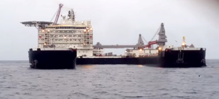 Illustration for article titled This is now Earth's largest ship—so big it can lift oil rigs off the sea